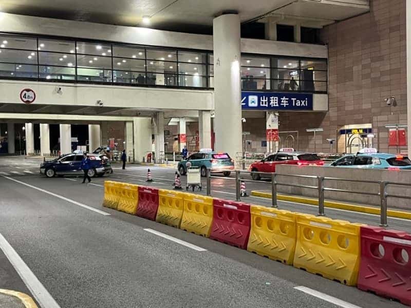 PVG to downtownShanghai-offial taxi queueoutside Pudong Airport at night